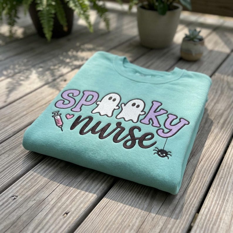 Spooky Nurse embroidery design on a finished aqua sweatshirt