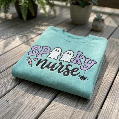 Spooky Nurse embroidery design on a finished aqua sweatshirt