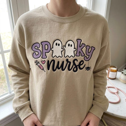 Spooky Nurse embroidery design worn on a finished cream sweatshirt