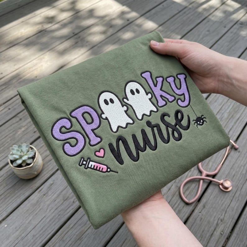 Spooky Nurse embroidery design on a finished green sweatshirt