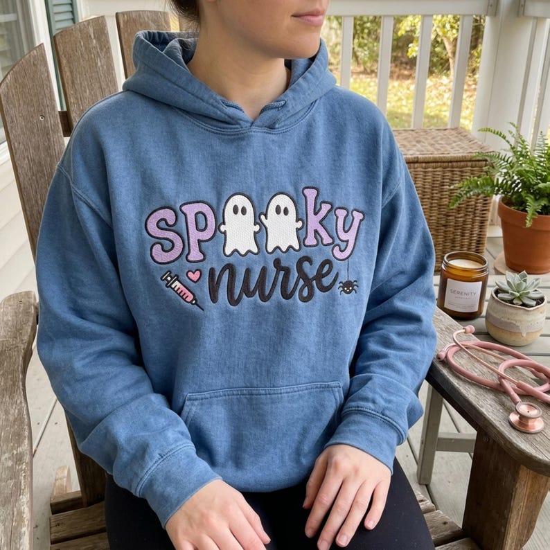 Spooky Nurse embroidery design worn on a finished blue hoodie