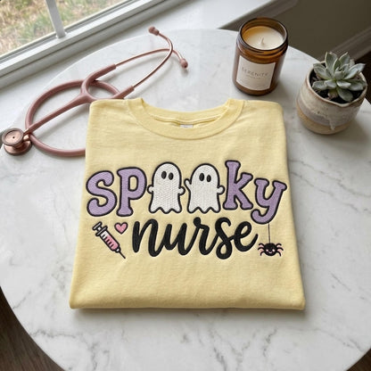 Spooky Nurse embroidery design on a finished yellow sweatshirt