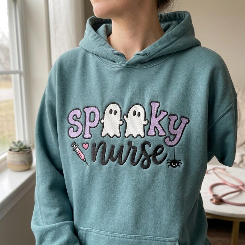 Spooky Nurse embroidery design worn on a finished teal hoodie