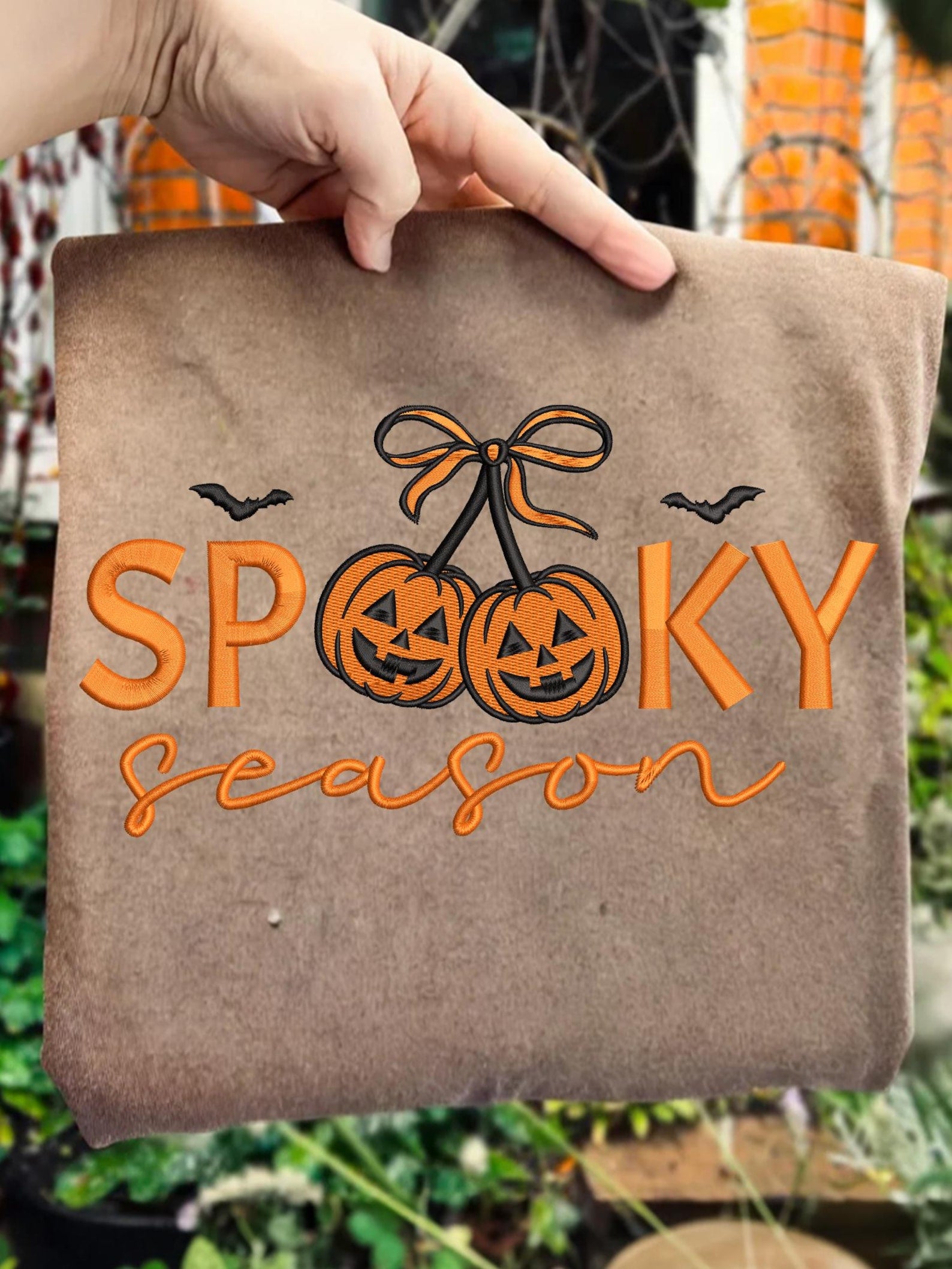 Spooky Season pumpkin cherries embroidery design on a finished brown tote as a design reference