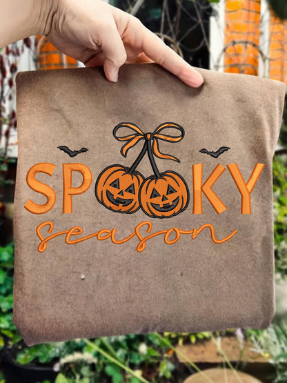 Spooky Season pumpkin cherries embroidery design on a finished brown tote as a design reference