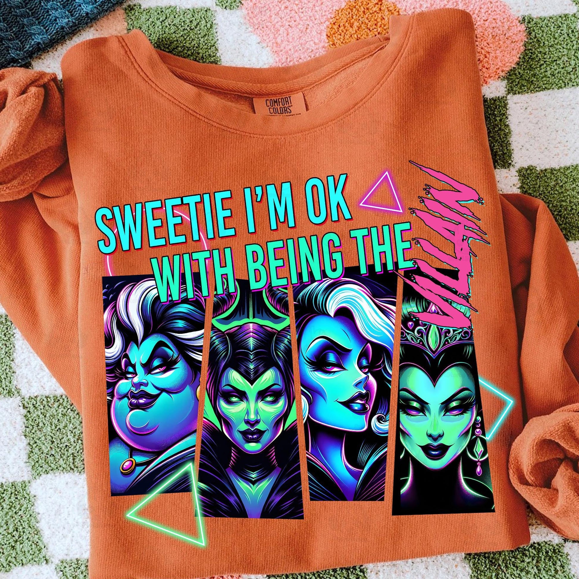 Sweetie I’m OK with Being the Villain Halloween DTF transfer on an orange sweatshirt