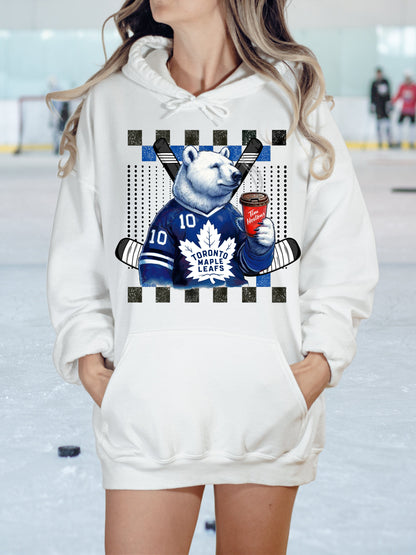 a woman wearing a white hoodie with a bear on it