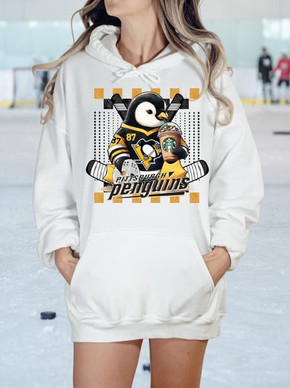 a woman wearing a penguins hoodie standing in the snow