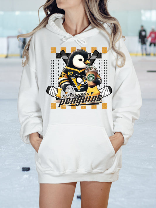 a woman wearing a penguins hoodie standing in the snow