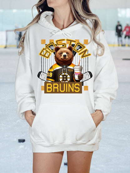 a woman wearing a white hoodie with a brown bear on it