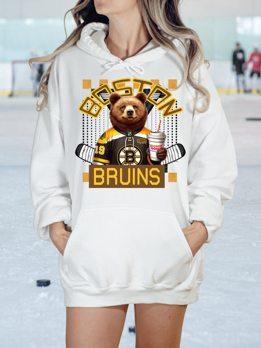 a woman wearing a white hoodie with a brown bear on it