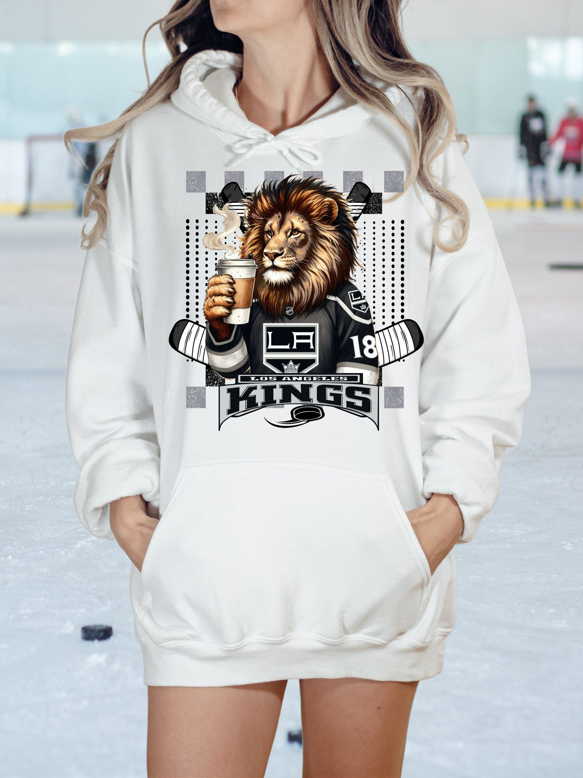 a woman wearing a white hoodie with a lion on it