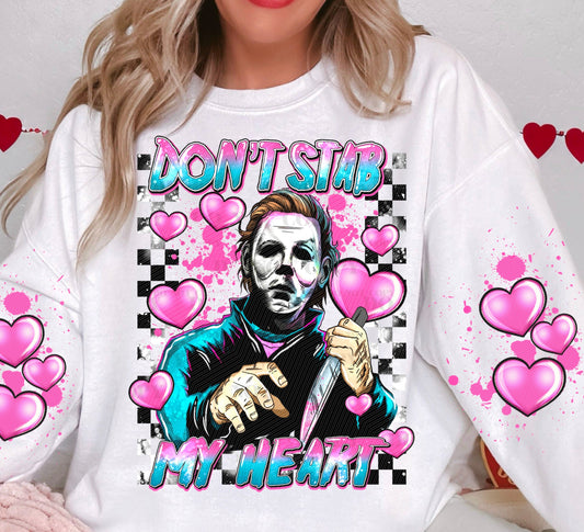 a woman wearing a t - shirt with a picture of a man holding a knife
