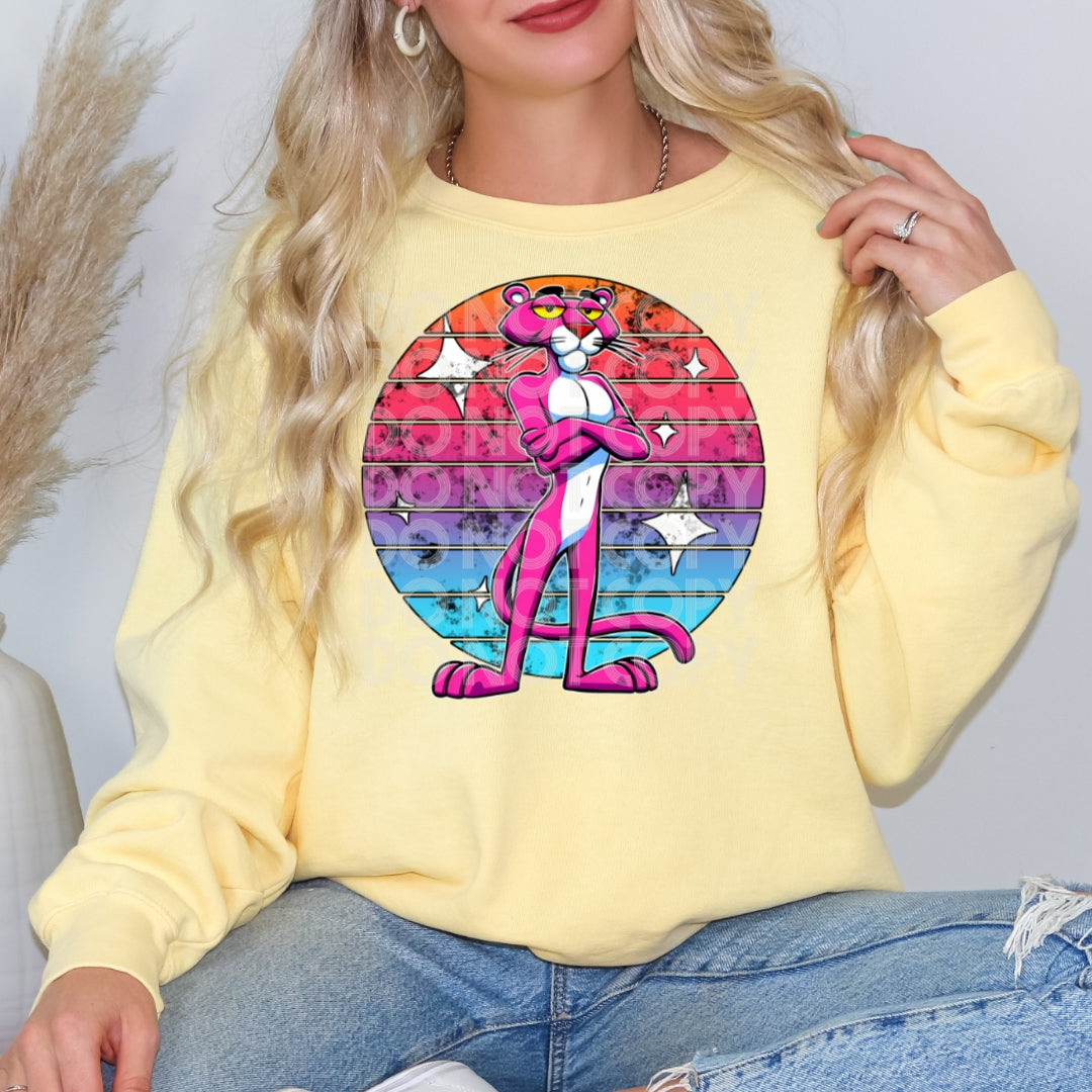 a woman wearing a yellow shirt with a pink cat on it