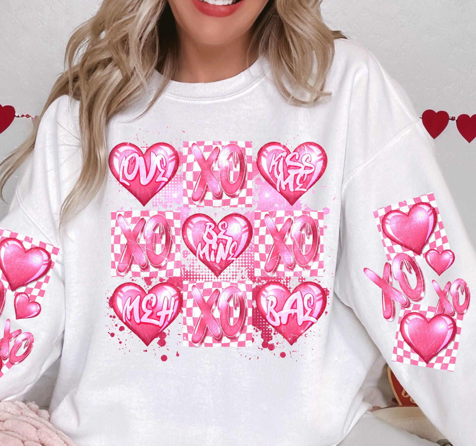 a woman wearing a white shirt with pink hearts on it