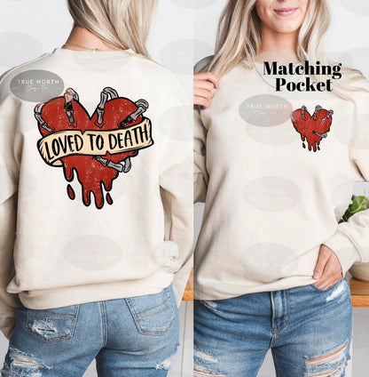 a woman wearing a sweatshirt with the words loved to death on it