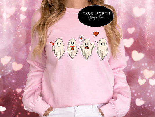 a woman wearing a pink sweater with ghost faces on it