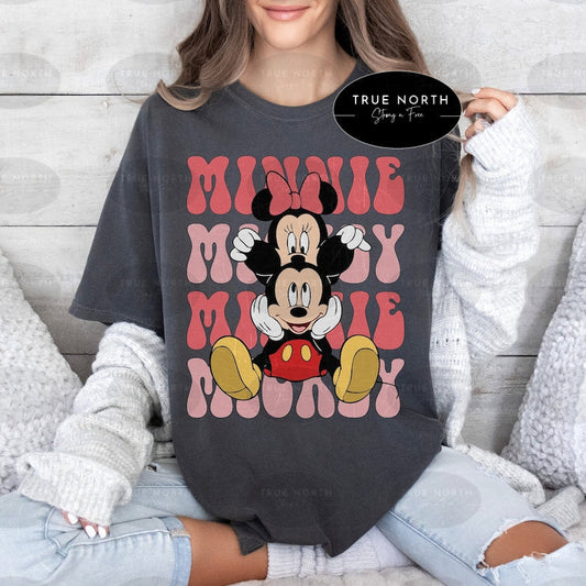 a woman wearing a mickey mouse t - shirt