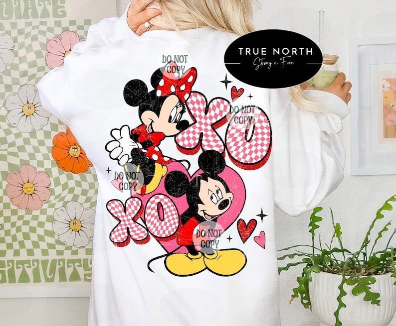 a woman wearing a white shirt with minnie mouse on it