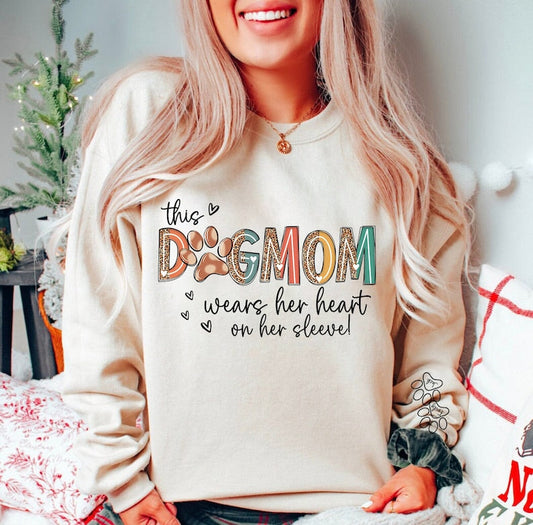 a woman with blonde hair wearing a dog mom sweatshirt