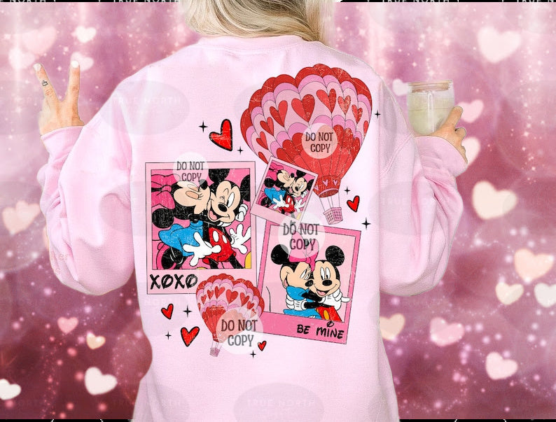 a woman wearing a pink mickey mouse shirt