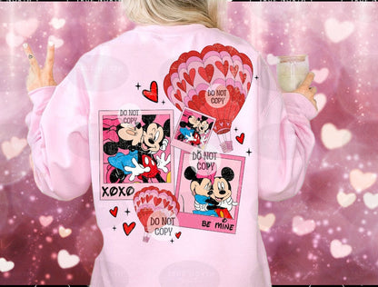 a woman wearing a pink mickey mouse shirt