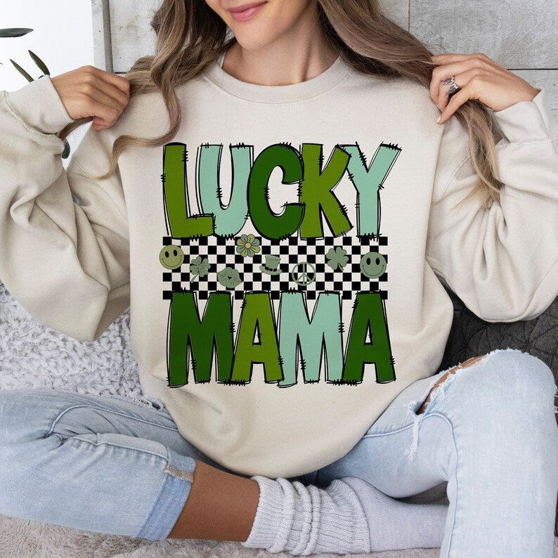 a woman sitting on a couch wearing a sweatshirt that says lucky mama