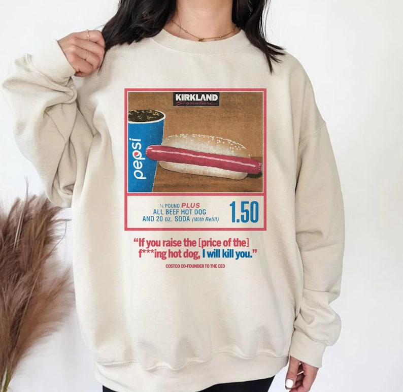a woman wearing a sweatshirt with a picture of a hot dog on it