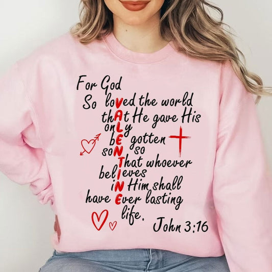 a woman wearing a pink sweatshirt with a cross on it